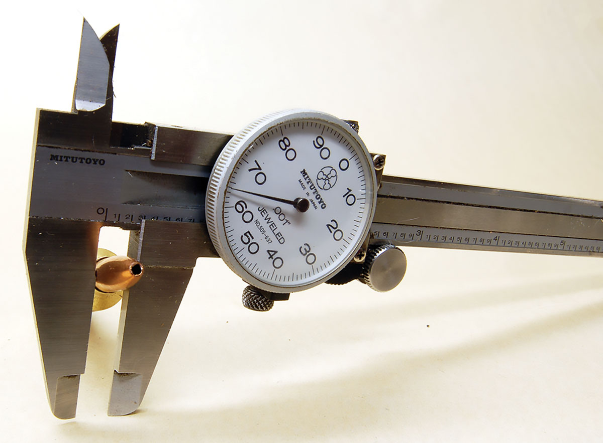 A caliper showing the 26 Nosler uses common .264-inch bullets.